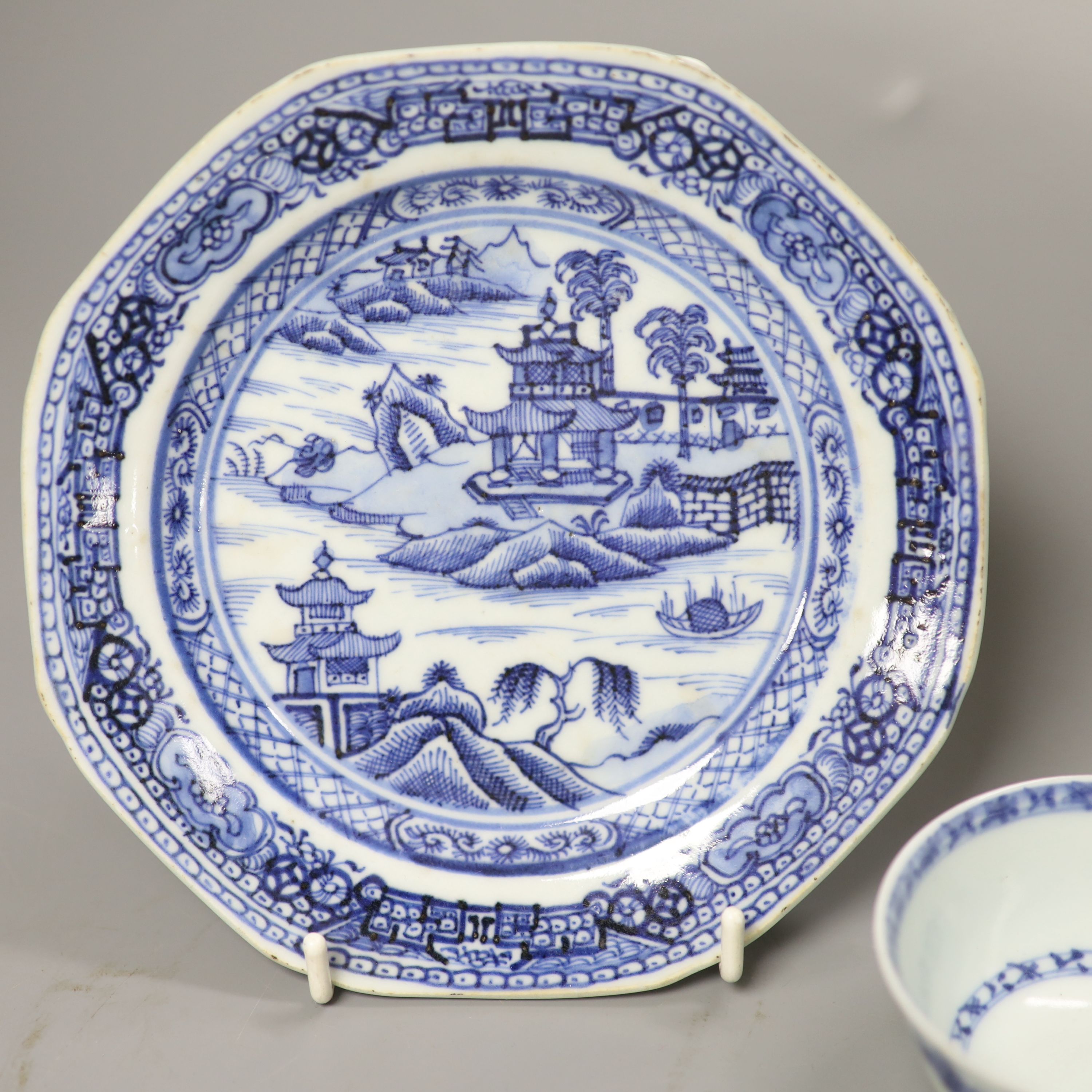 A Chinese 18th century Nanking Cargo blue and white tea bowl and saucer and a small blue and white octagonal plate, W 16cm (plate)